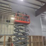 Two workers from Reed's Demolition and Cleanouts LLC in a lift