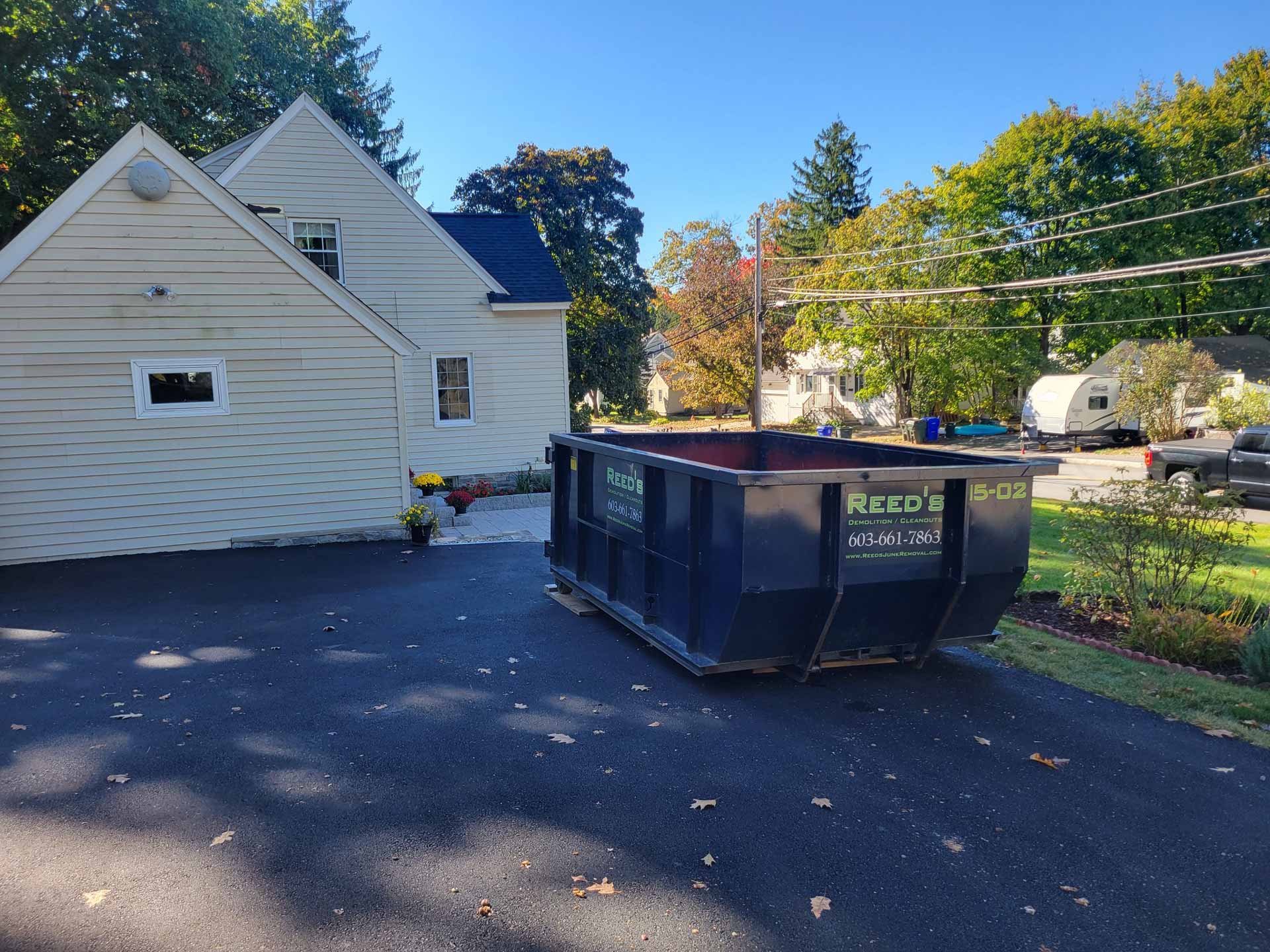 Reed's dumpster in driveway
