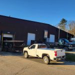 Reed's trucks and dumpsters parked outside of warehouse