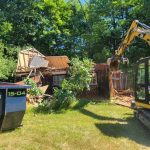 Garage demolition underway with Reed's dumpster on site