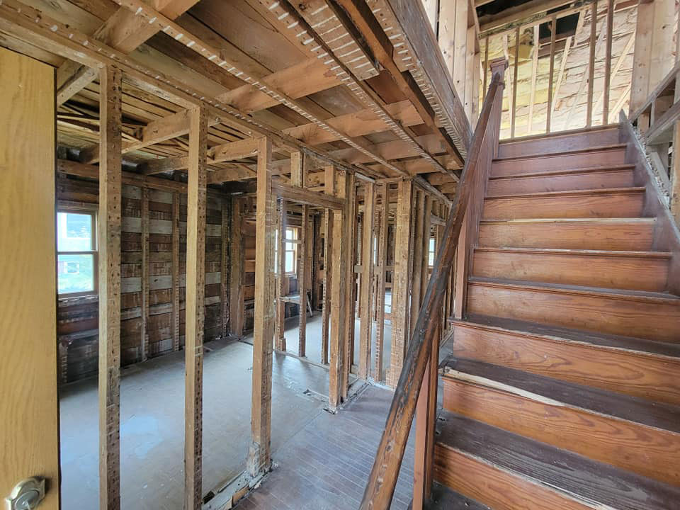 Interior of house with walls and flooring stripped away