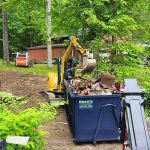 Demolition contractor loading up rental dumpster from Reed's Demolition & Cleanouts LLC