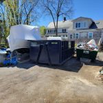 Rental dumpster from Reed's Demolition & Cleanouts LLC in driveway