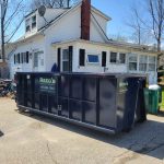 Reed's Demolition & Cleanouts LLC rental dumpster in driveway