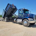 Reed's Demolition & Cleanouts LLC truck unloading a dumpster