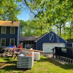 Rental dumpster from Reed's Demolition & Cleanouts LLC in use during roofing project